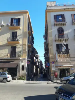 a city street with two buildings and cars parked at Dimora al Capo in Palermo