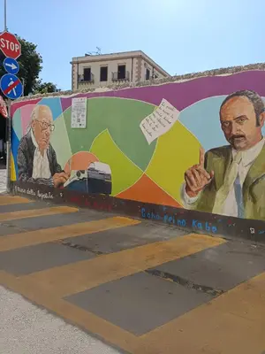 a mural of two men on a bus stop at Dimora al Capo in Palermo