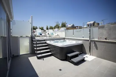 a balcony with a tub on top of a building at Acquarò Suite Apartments in San Vito lo Capo