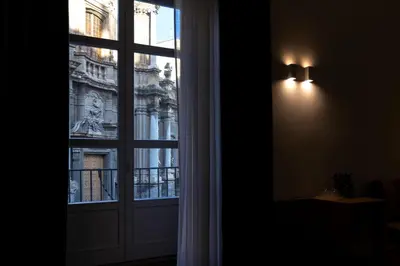 a window with a view of a building at Vespri Luxury Rooms & Suites in Palermo