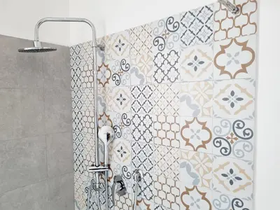 a shower in a bathroom with a tile wall at Enne's Apartments in the heart of Palermo in Palermo