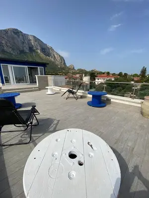 a white table and chairs on a patio with a view at B&B Torre Pozzillo in Cinisi