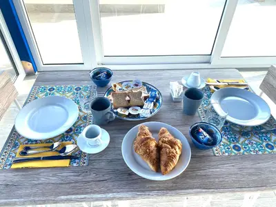 a table with plates of food on a table at B&B Torre Pozzillo in Cinisi