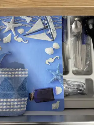 a drawer with a blue package with shells on it at Casetta Blu Mondello zona Partanna in Palermo