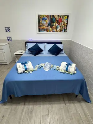 a bedroom with a blue bed with a blue blanket at Casetta Blu Mondello zona Partanna in Palermo