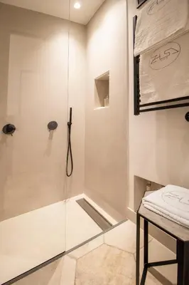 a shower with a glass door in a bathroom at Zisa Suite in Palermo