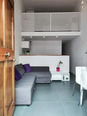 a living room with a couch and purple pillows at A NICAREDDA in Palermo