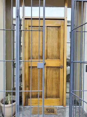 a wooden door in front of a building at A NICAREDDA in Palermo
