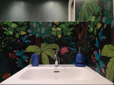 a bathroom with a sink with a colorful wall at A NICAREDDA in Palermo