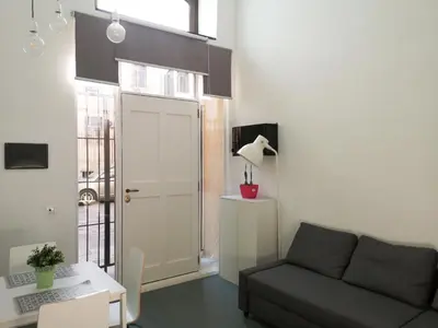 a living room with a couch and a table and a window at A NICAREDDA in Palermo
