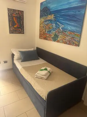 a bed in a room with a painting on the wall at ART GALLERY HOUSE La casa dell’arte in Palermo