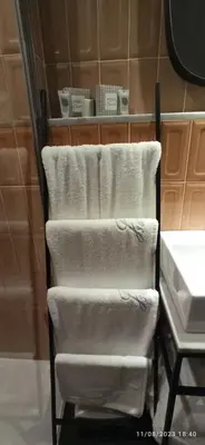 a towel rack with white towels on it in a bathroom at Jacona 365 in Palermo