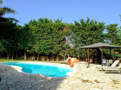 a swimming pool with a tent and chairs and an umbrella at Villa Carta Fashion by Interhome in Terrasini