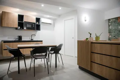 a kitchen with a table and chairs in a room at Case vacanza Puccini in Alcamo