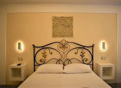 a bedroom with a black bed with two pillows at Federico 70 Zaffiro Luxury in Palermo