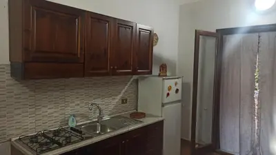 a kitchen with a sink and a white refrigerator at House Italia Holiday in Trabia