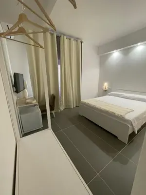 a bedroom with a bed and a tv in it at Milu's Home in Palermo