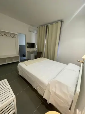 a bedroom with a large white bed in a room at Milu's Home in Palermo