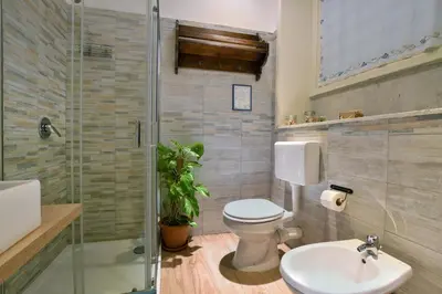 a bathroom with a toilet and a sink and a shower at iFlat Palazzo Ragusi in Palermo