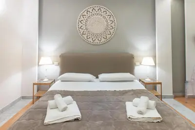a bedroom with a large bed with towels on it at Federico 70 Smeraldo in Palermo