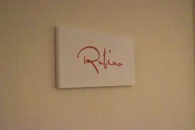 a white sign on a wall with the word ritz at Federico 70 Rubino in Palermo