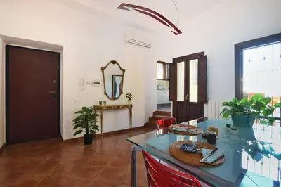 a living room with a table and a mirror at iFlat Casa Tesò con terrazza sui tetti in Palermo