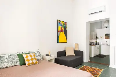 a kitchen with white cabinets and a sink at Vucciria Apartments by Wonderful Italy in Palermo