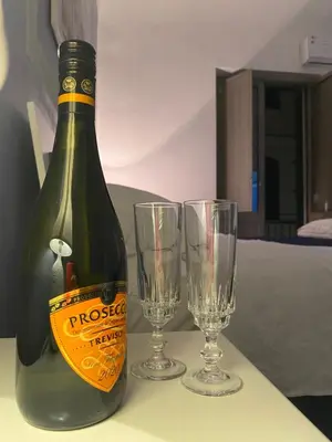 a bottle of wine and two glasses on a table at Luna Blu Apartment in Palermo