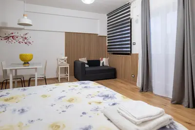 a bedroom with a bed and a chair and a table at Sweet Home in Palermo