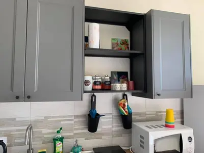 a kitchen with a counter with a sink and a microwave at CALA MARE in Palermo
