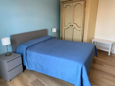 a blue bedroom with a blue bed and a door at CALA MARE in Palermo