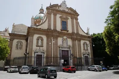 an old building with cars parked in front of it at Casa Miqvà - Rooms in shared apartment in Palermo