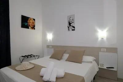 a bedroom with a bed with two towels on it at Villa Dolce Vita rooms in Castelluzzo