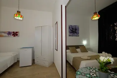 a bedroom with a bed and a mirror at Villa Dolce Vita rooms in Castelluzzo