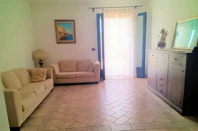 a living room with a couch and a chair at Casa del Grecale in Isola delle Femmine
