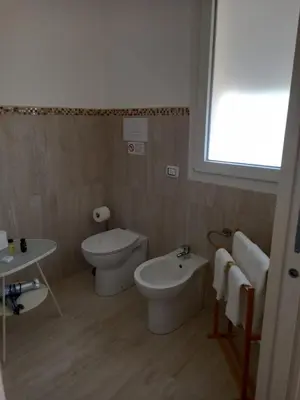 a bathroom with a toilet and a bidet and a sink at Villa Serendipity Terrasini in Terrasini
