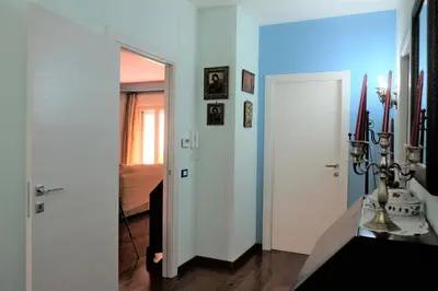 a hallway with a white door and a room with a bed at Palermo old style - Boutique apartment with terrace in center city in Palermo