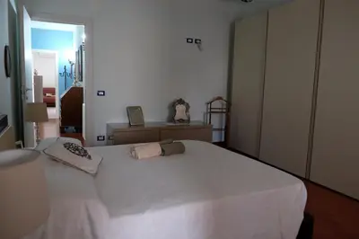 a bedroom with a white bed with two pillows on it at Palermo old style - Boutique apartment with terrace in center city in Palermo