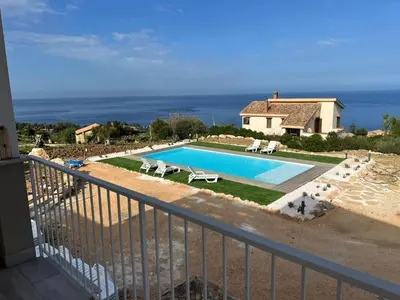 a swimming pool in front of a house at Apt Perterrepermari a 2 Km Da Riserva Dello Zingaro in Scopello