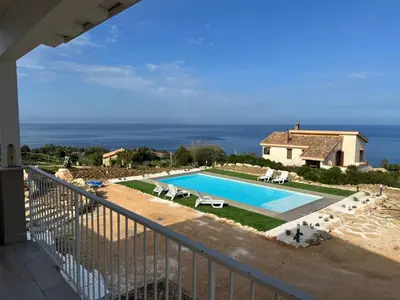 a swimming pool in front of a house at Apt Perterrepermari a 2 Km Da Riserva Dello Zingaro in Scopello