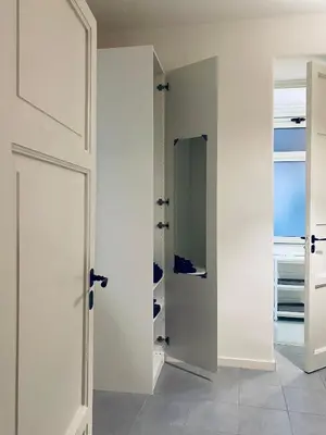 a white room with a door and a mirror at Da Marlà al Politeama in Palermo