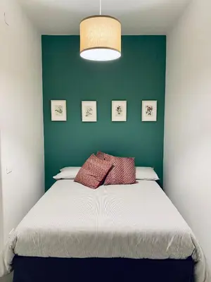 a bedroom with a large bed with a green wall at Da Marlà al Politeama in Palermo