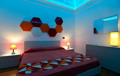 a bedroom with a bed with two lights on it at Casa Mare in San Vito lo Capo