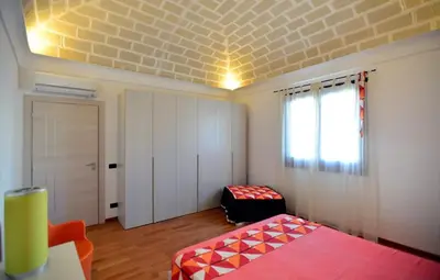 a room with a bedroom with a bed and a window at Casa Mare in San Vito lo Capo