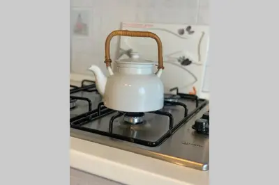 a white tea kettle sitting on top of a stove at Casa vacanza - I Mulini con parcheggio gratuito incluso. in Monreale