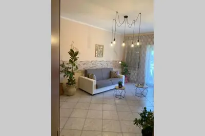 a living room with a couch and a table at Casa vacanza - I Mulini con parcheggio gratuito incluso. in Monreale