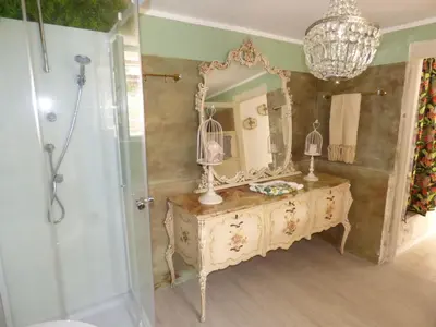 a bathroom with a vanity with a mirror and a shower at Relais dei Mori Home Palermo in Casteldaccia