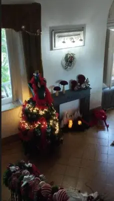 a living room with a christmas tree and a fireplace at Relais dei Mori Home Palermo in Casteldaccia