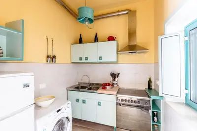 a kitchen with a washing machine and a washer at Casa Dante with Balcony by Wonderful Italy in Palermo