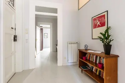 a hallway with a book shelf with books at Casa Dante with Balcony by Wonderful Italy in Palermo